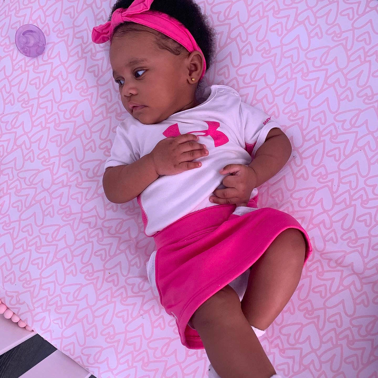 Gianna joined the competition — help win amazing prizes! baby, baby_toddler_clothing, cap, child, comfort, face, head, human_body, human_leg, knee, leg, magenta, person, pink, purple, skin, sleeve, thigh, toddler, trunk