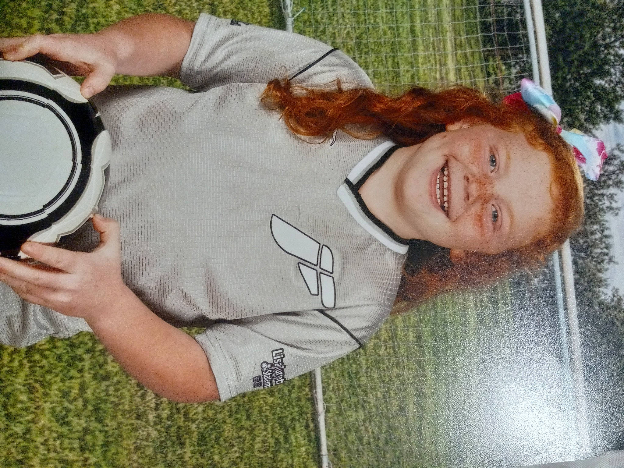 Alissa joined the competition — help win amazing prizes! audio_equipment, child, cool, eyewear, fun, gesture, grass, green, happy, joy, leisure, person, personal_protective_equipment, plant, recreation, single_lens_reflex_camera, smile, t_shirt, tree, window