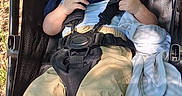 Jasper is registered to the contest to win money with this photo: toddler, stroller, child, baby, smiling, outdoor, sunlight, shadow, blanket, clothing, feet, seatbelt, black, fabric, playful, relaxed, infant, person, portrait, sitting