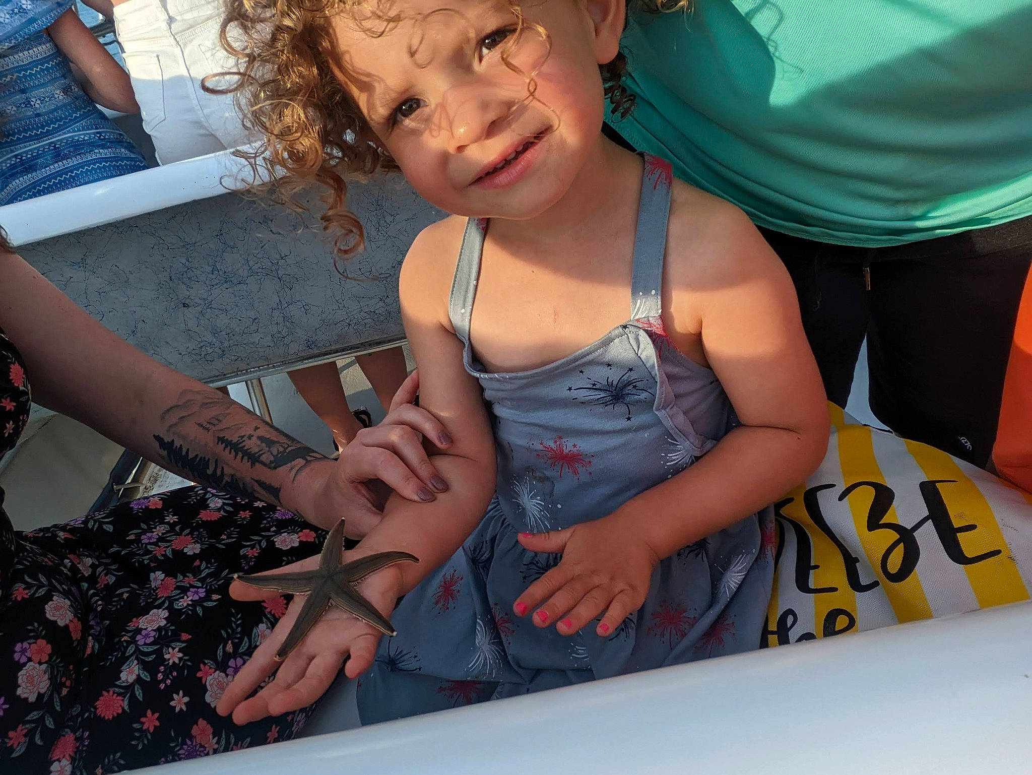 Addilynn is registered to the contest to win money with this photo: child, cool, finger, fun, gesture, happy, human, human_leg, joint, leisure, mouth, nail, pattern, person, recreation, sitting, summer, thigh, thumb, toddler