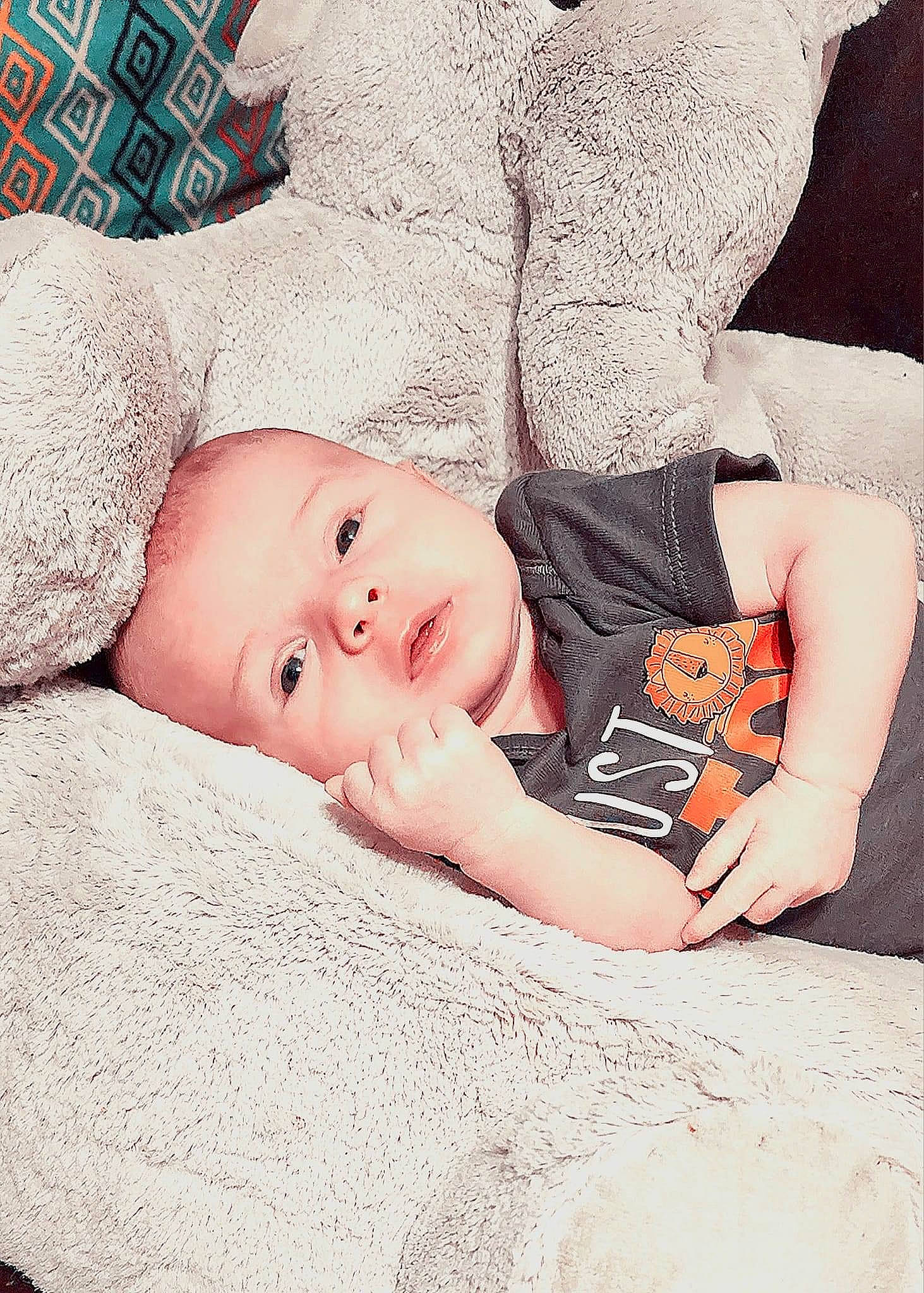 Wyatt is registered to the contest to win money with this photo: baby, baby_sleeping, baby_toddler_clothing, bedding, bedtime, child, comfort, eye, flesh, fur, happy, head, human_body, linens, pattern, person, room, sitting, skin, sleeve