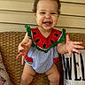 toddler, child, smiling, watermelon_outfit, sitting, happy, hair_ties, wicker_bench, pillow, clothing, cute, person, baby, portrait, indoors, feet, hands, face, playful, colorful