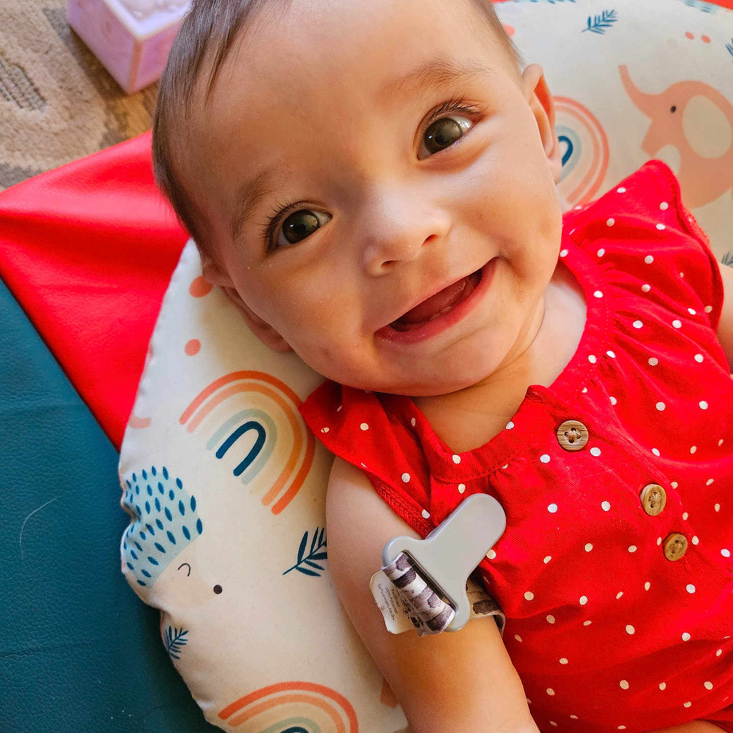 Ava is registered to the contest to win money with this photo: accessories, arm, baby, bodypart, clothing, couch, cushion, face, finger, furniture, hand, happy, head, homedecor, person, photography, portrait, smile, t_shirt, wallet