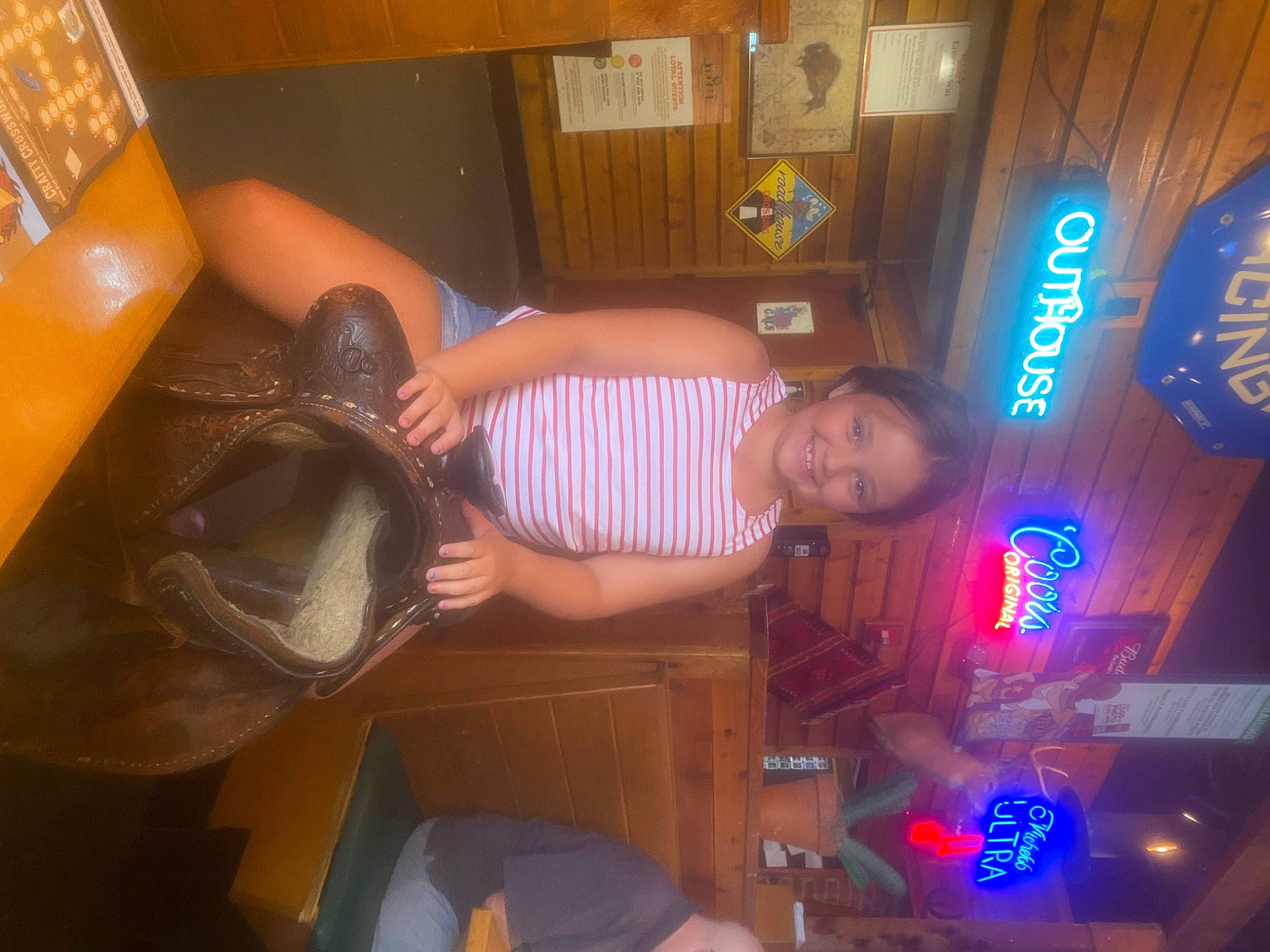 Alivia joined the competition — help win amazing prizes! ceiling, curtain, finger, fun, joy, machine, person, recreation, room, shelf, smile, space, t_shirt, thigh, wood