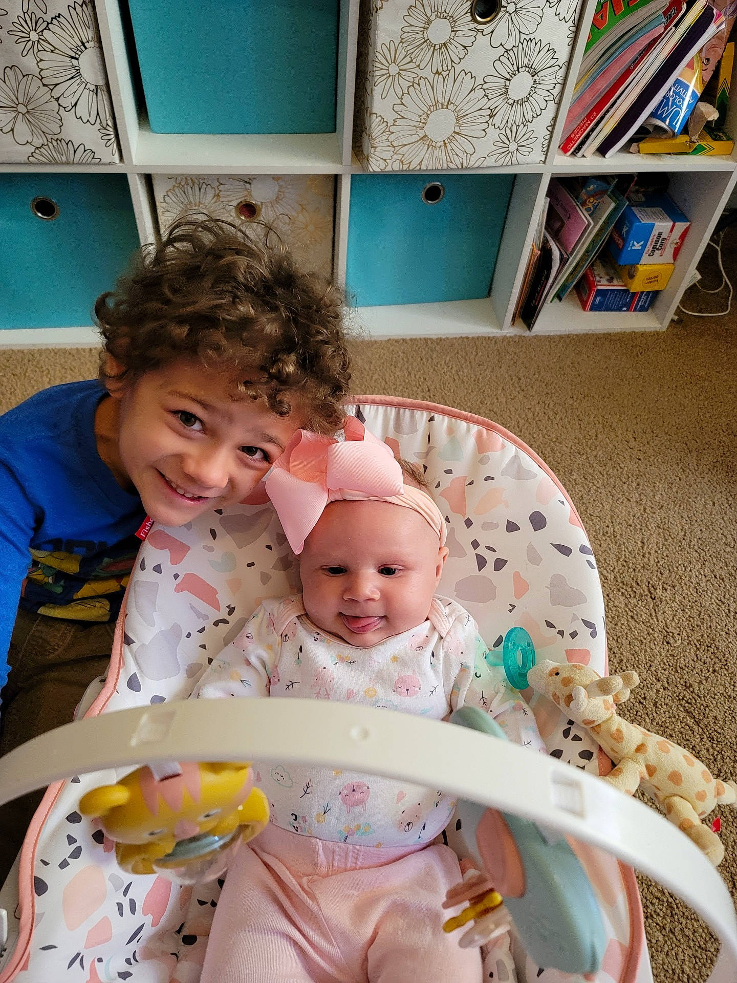 Phoenix joined the competition — help win amazing prizes! baby, baby_toddler_clothing, blue, bookcase, cheek, child, comfort, eye, facial_expression, fun, green, happy, head, joy, mammal, person, shelf, skin, smile, snapshot