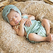 Layla Rose is registered to the contest to win money with this photo: newborn, baby, sleeping, infant, blanket, basket, soft_texture, cozy, cute, peaceful, resting, clothing, headwear, closeup, indoors, portrait, small_hands, small_feet, delicate, baby_bonnet