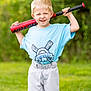 child, boy, baseball_bat, sportswear, outdoor, greenery, grass, smile, short_hair, blue_shirt, white_pants, playing_sports, recreation, youth, fun, happy, portrait, summer, active, team