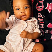 Sarayah joined the competition — help win amazing prizes! baby, infant, onesie, sock, blanket, curly_hair, cute, indoor, portrait, child, smiling, hand, face, lying_down, clothing, soft_toys, cozy, young_child, expression, person