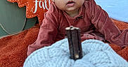 Zaliyah is registered to the contest to win money with this photo: autumn, baby, blanket, bow, child, curious, face, fall, forest, grass, hair_bow, infant, knitted_pumpkin, nature, orange, outdoor, portrait, pumpkin, rustic, sitting