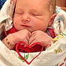 Luke joined the competition — help win amazing prizes! newborn, baby, infant, sleeping, blanket, wrapped, hands, heart_shape, red_heart_doodle, closeup, soft_light, indoors, peaceful, cute, skin, person, portrait, resting, cozy, toddler