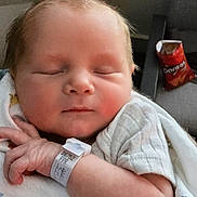 Luke joined the competition — help win amazing prizes! newborn, baby, sleeping, blanket, hospital_wristband, indoor, baby_clothing, face, infant, hand, furniture, chair, snack, doritos, relaxing, portrait, peaceful, resting, child, person