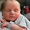 Luke is registered to the contest to win money with this photo: newborn, baby, sleeping, blanket, hospital_wristband, infant, face, arm, hand, clothing, chair, bag, snack, doritos, indoor, person, peaceful, resting, cute, name_overlay