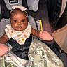 Zuri joined the competition — help win amazing prizes! baby, infant, child, car_seat, pink_bow, floral_outfit, blanket, smiling, portrait, indoors, sitting, harness, foot, sock, cozy, vehicle, safety_seat, black_fabric, photography, adorable