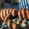 baby, infant, sleeping, portrait, indoors, blanket, couch, sunlight, shadows, striped_light, colorful, resting, lying_down, face, hand, diaper, home, close_up, peaceful, photography
