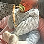 baby, newborn, sleeping, pacifier, knitwear, socks, person, couch, cushion, hand, indoor, cozy, soft, child, infant, cute, rest, comfort, warm, peaceful