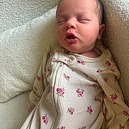 Amelia joined the competition — help win amazing prizes! baby, newborn, sleeping, onesie, floral_pattern, blanket, cozy, soft_texture, infant, cute, mouth_open, peaceful, closeup, child, portrait, resting, indoors, warm, comfort, relaxed
