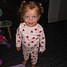 toddler, child, pajamas, hearts, barefoot, indoor, floor, toy, blanket, pigtails, pink, blue_eyes, smiling, person, clothing, striped_floor, playroom, furniture, curious, standing