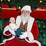 Lucas joined the competition — help win amazing prizes! baby, santa_claus, christmas, holiday, festive, green_couch, red_suit, white_gloves, beard, glasses, garland, ornaments, pinecone, indoor, portrait, celebration, child, seasonal, decorations, smile
