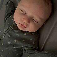 Lucas joined the competition — help win amazing prizes! baby, sleeping, onesie, star_pattern, pacifier, infant, child, bed, rest, peaceful, soft_lighting, indoors, portrait, face, head, sleepwear, cozy, cute, newborn, relaxation