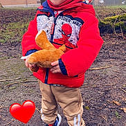 Loevan a rejoint le concours — aidez-le/la à gagner de superbes lots ! child, red_jacket, spiderman, plush_toy, winter_hat, outdoor, muddy_ground, sneakers, beige_pants, tree, grass, leafless_trees, smiling, cute, playful, winter_clothing, person, nature, heart_emoji, daytime