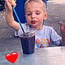 Lynezia participe au concours pour gagner de l'argent avec cette photo : child, boy, drink, plastic_cup, straw, scrapes, face, outdoor, table, plants, flowers, greenery, casual_clothing, parking_lot, cars, red_heart_emoji, concrete, daylight, expression, curious