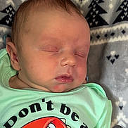 Joshua Jr joined the competition — help win amazing prizes! baby, sleeping, infant, tshirt, dinosaur, text, blanket, pattern, face, head, cute, peaceful, child, clothing, resting, portrait, young, indoors, person, newborn