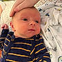 Joshua Jr joined the competition — help win amazing prizes! baby, infant, hand, striped_clothing, blanket, bed, soft_toys, person, newborn, sleepwear, fabric, comfort, resting, indoor, skin, face, closeup, caring, toddler, cute