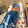 Joshua Jr is registered to the contest to win money with this photo: newborn, baby, hospital, bassinet, pacifier, blanket, hat, swaddled, infant, bed, footprint_pattern, blue, sleeping, person, indoor, closeup, cute, resting, child, maternity