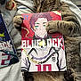 animal, book, cat, close_up, clutching, cozy, cute, entertainment, feline, indoor, lying_down, manga, paws, pet, reading, relaxed, resting, soft_texture, striped_blanket, tabby_cat