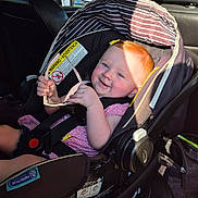 Myleigh joined the competition — help win amazing prizes! baby, car_seat, child, red_hair, sunglasses, smile, sunlight, car_interior, seatbelt, pink_clothing, happy, infant, safety, vehicle, cute, person, seat, head_support, toddler, sunshine