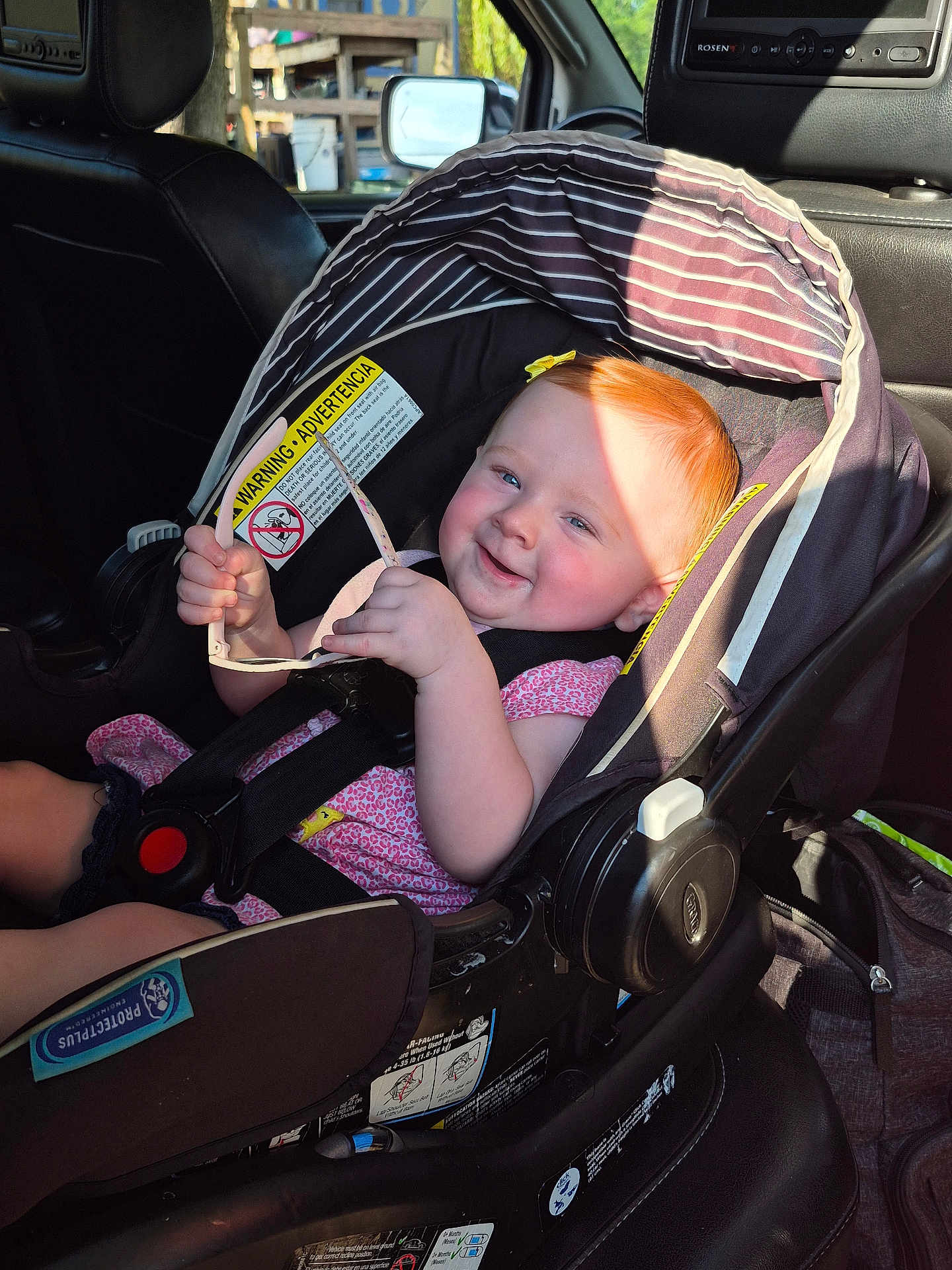 Myleigh joined the competition — help win amazing prizes! baby, car_seat, child, red_hair, sunglasses, smile, sunlight, car_interior, seatbelt, pink_clothing, happy, infant, safety, vehicle, cute, person, seat, head_support, toddler, sunshine