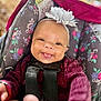 baby, babylaughing, bodypart, clothing, coat, cushion, face, finger, hand, happy, hat, head, jacket, person, photography, portrait, purple, smile, transportation, vehicle