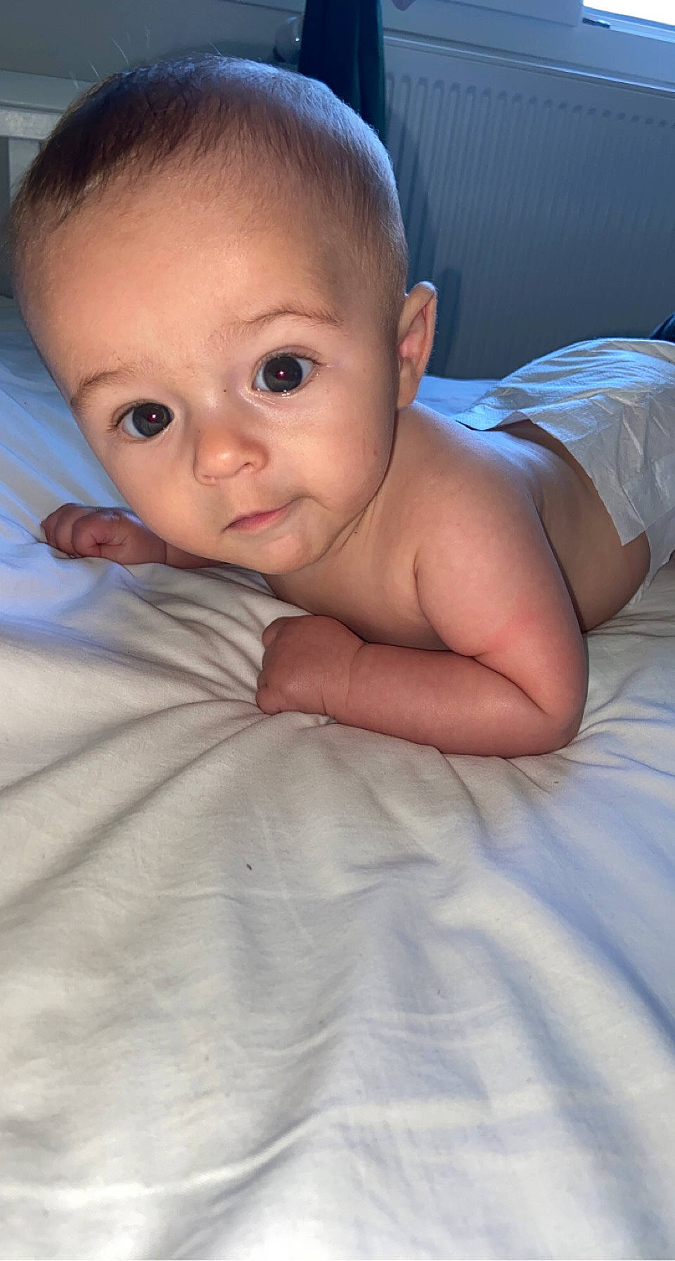 Nolan participe au concours pour gagner de l'argent avec cette photo : baby, baby_toddler_clothing, cheek, chin, comfort, eye, eyebrow, finger, flash_photography, hairstyle, head, human_body, iris, lip, mouth, neck, nose, person, skin, stomach