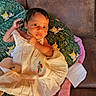 Jorjiana joined the competition — help win amazing prizes! baby, infant, dress, pillow, couch, blanket, foot, face, person, indoors, child, cute, green, pink, brown, pattern, comfort, relaxing, small, young