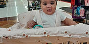 Ni'Amani is registered to the contest to win money with this photo: aisle, baby, child, clothing, cushion, cute, floor, grocery_store, hair_bow, indoor, infant, person, retail, shelf, shoes, shopping, shopping_cart, smiling, store, toy