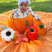 Wrenlee is registered to the contest to win money with this photo: baby, pumpkin, orange_blanket, flower, headband, outdoor, grass, fall, cute, infant, decor, costume, autumn, sitting, child, nature, portrait, seasonal, smiling, holiday