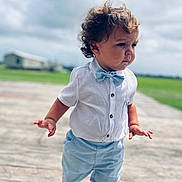 Easton joined the competition — help win amazing prizes! baby, blue_shorts, bow_tie, child, cloudy_sky, curly_hair, cute, daylight, fashion, green_field, outdoor, person, portrait, serious_expression, standing, summer_clothing, toddler, walking, white_shirt, wooden_floor