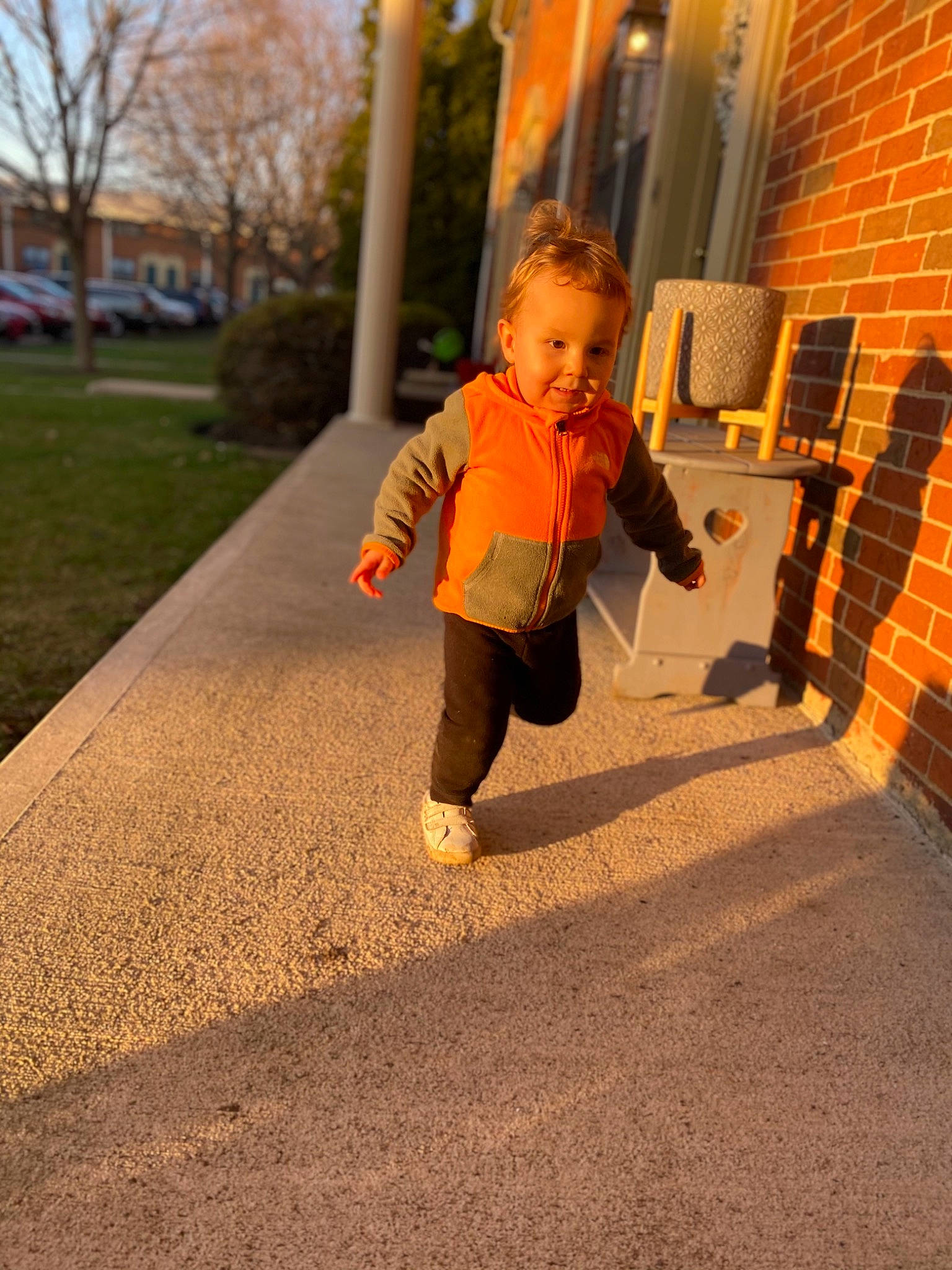 Patrick joined the competition — help win amazing prizes! asphalt, baby, floor, flooring, grass, hand, happy, human_body, jacket, leg, orange, people_in_nature, person, plant, road_surface, sidewalk, sleeve, t_shirt, toddler, tree