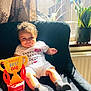 Dylan is registered to the contest to win money with this photo: baby, child, smiling, indoor, chair, sock, toy, trophy, sunlight, window, plant, curtain, clothing, bracelet, happy, portrait, cozy, furniture, person, celebration