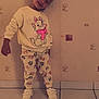 Lilou participe au concours pour gagner de l'argent avec cette photo : casual_clothing, cat_print, child, cute, fashion, happy, indoor, kid, pants, patterned_wall, person, playful, portrait, pose, smiling, standing, sweatshirt, tiled_floor, wallpaper, white_sneakers