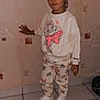 Lilou a rejoint le concours — aidez-le/la à gagner de superbes lots ! casual_wear, cat_print, child, clothing, comfortable, cozy, cute, disney, footwear, hand_on_wall, indoor, looking_down, pants, patterned_wall, sneakers, standing, sweatshirt, tile_floor, wall, young_child