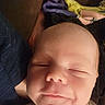 Adonis is registered to the contest to win money with this photo: baby, sleeping, close_up, face, smile, infant, skin, tattoo, blanket, cozy, peaceful, portrait, human, newborn, relaxation, comfort, indoors, rest, cute, head