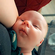 Adonis joined the competition — help win amazing prizes! baby, infant, face, closeup, sleeping, skin, arm, clothing, green_shirt, red_background, indoor, child, newborn, peaceful, resting, portrait, soft_light, cute, person, human