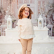 Kamelia participe au concours pour gagner de l'argent avec cette photo : background, barefoot, beige_pants, beret, child, cozy, curly_hair, cute, decor, festive, holiday, indoor, lantern, lighting, playful, portrait, smiling, snow, white_sweater, winter_clothing
