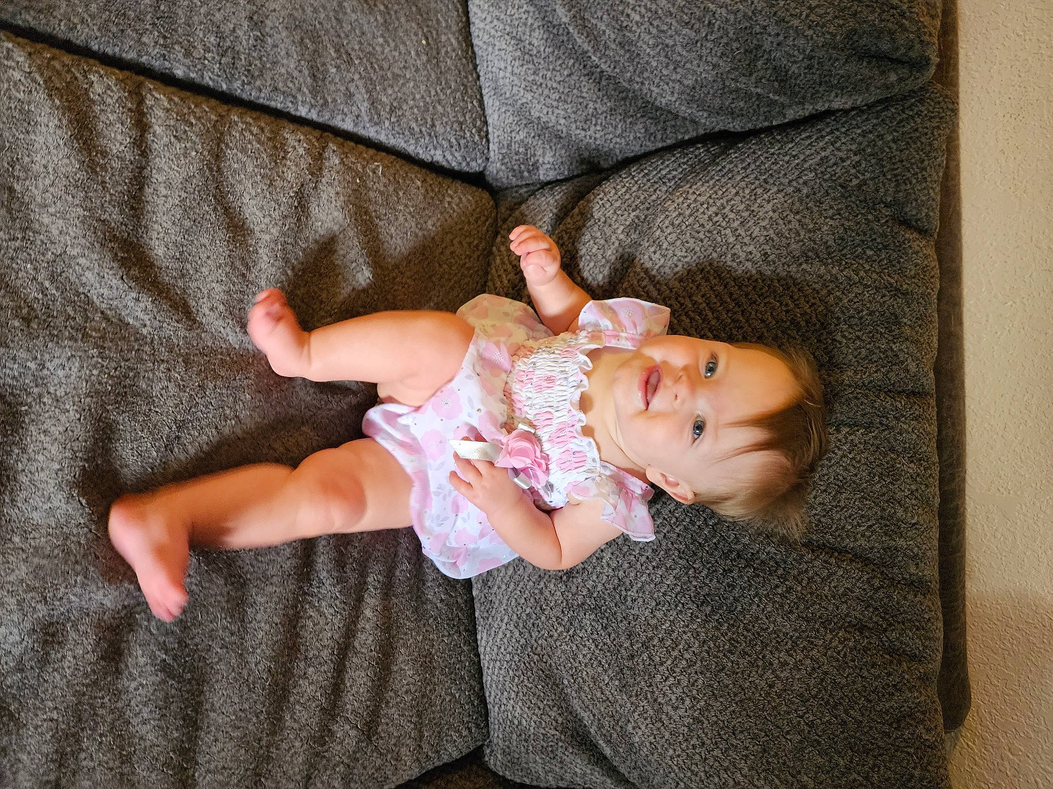 Alexis is registered to the contest to win money with this photo: baby, baby_products, baby_toddler_clothing, cheek, comfort, fawn, finger, foot, grass, human_body, human_leg, joy, leg, linens, pattern, person, sitting, sleeve, sock, thigh