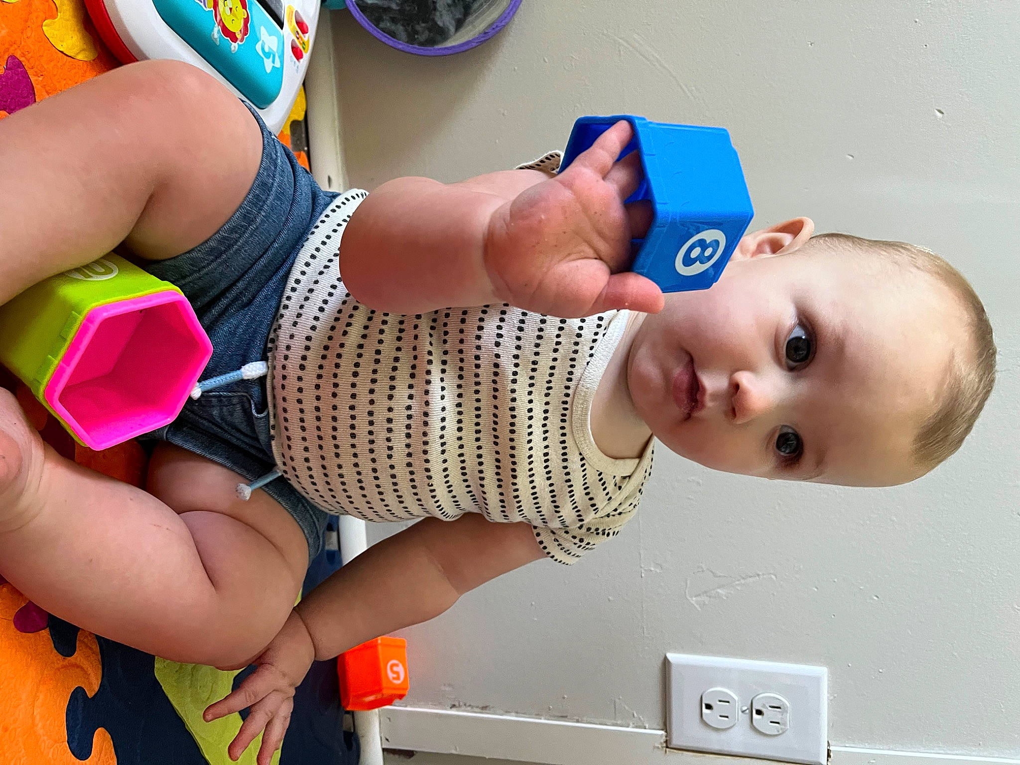 Langston is registered to the contest to win money with this photo: baby, baby_toddler_clothing, beauty, blue, child, facial_expression, finger, fun, happy, hat, headgear, human_leg, knee, mouth, people, person, product, smile, snapshot, thigh