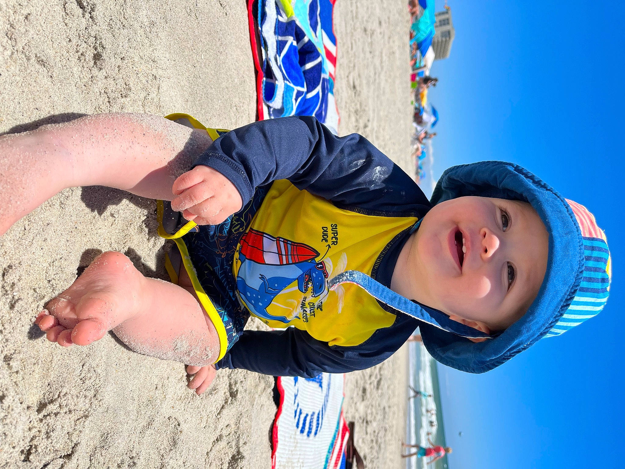 Langston joined the competition — help win amazing prizes! adventure, blue, child, climbing_harness, electric_blue, fun, happy, hat, headwear, leisure, outdoor_play_equipment, people, person, play, recreation, sand, sky, smile, soil, toddler