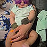 Ian is registered to the contest to win money with this photo: baby, child, sunglasses, mittens, adult, hand, nails, orange_nails, striped_clothing, wicker_chair, towel, indoor, person, seated, casual, cute, portrait, relaxed, home, fashion_accessory