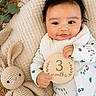 Ian is registered to the contest to win money with this photo: baby, infant, milestone, 3_months, crocheted_bunny, toy, blanket, cozy, cute, portrait, laying_down, wooden_plaque, smiling, child, clothing, patterned_onesie, soft_toys, homedecor, natural_light, happy