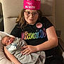 Savannah is registered to the contest to win money with this photo: child, newborn, baby, big_sister_crown, glasses, chair, blanket, smile, indoor, family, holding_baby, black_shirt, person, portrait, happy, toddler, resting, sibling, casual